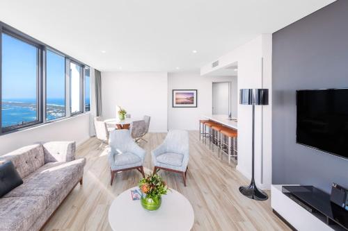 a living room with a couch and a tv at Meriton Suites Southport in Gold Coast