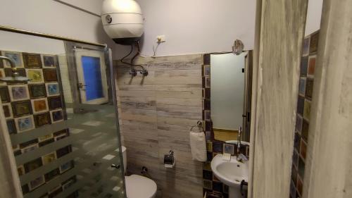 a bathroom with a sink and a toilet and a mirror at Shams Hotel & Dive Centre in Dahab