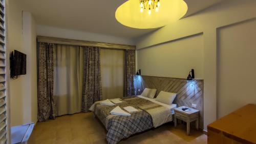 a bedroom with a bed and a chandelier at Shams Hotel & Dive Centre in Dahab