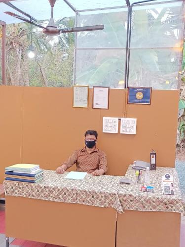 a man sitting at a table wearing a virtual reality glasses at Beach Nest in Kannur