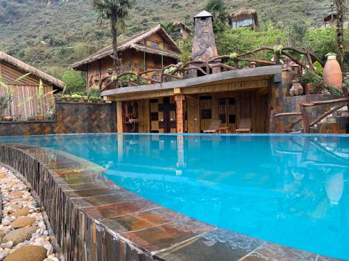 a house with a swimming pool in front of a house at Eco Palms House - Sapa Retreat in Sapa