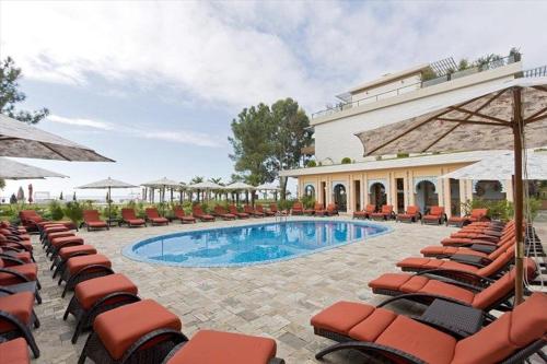 a resort with a swimming pool and lounge chairs at Dreamland deluxe apartment in Chakvi