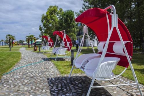 a row of empty chairs in a park at Dreamland deluxe apartment in Chakvi