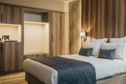 a bedroom with a large white bed with pillows at Idou Anfa Hôtel & Spa in Casablanca