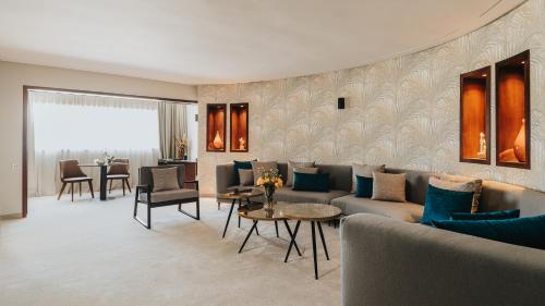 a living room with a couch and a table at Idou Anfa Hôtel & Spa in Casablanca