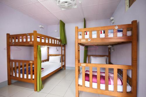 two bunk beds in a small room with a room with at Center.Center Hostel in Puli