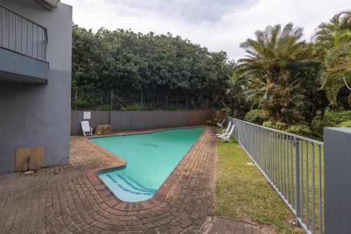 a swimming pool in the backyard of a house at Ramsgate Beach Club in Ramsgate