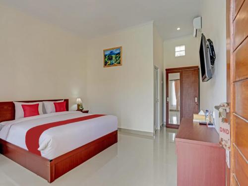 a bedroom with a large bed and a television at The Bingin Sari Jimbaran in Jimbaran