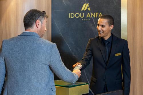a man shaking the hand of a man in a suit at Idou Anfa Hôtel & Spa in Casablanca