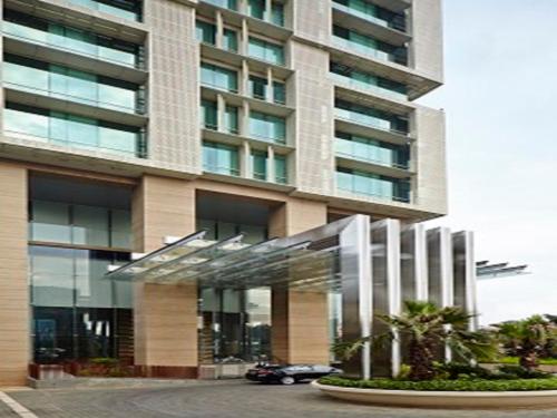 a building with a car parked in front of it at Fraser Residence Menteng Jakarta in Jakarta