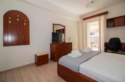 a bedroom with a bed and a dresser and a mirror at Spartan 5th floor apartment in Sparti