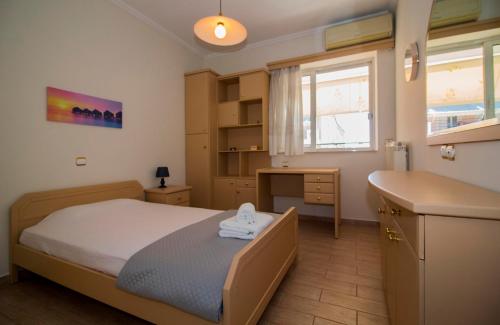 a bedroom with a bed and a desk and a sink at Spartan 5th floor apartment in Sparti