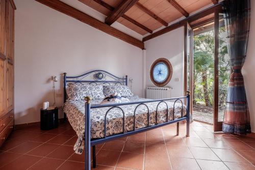 a bedroom with a bed in a room with a window at Ripabella in San Gimignano