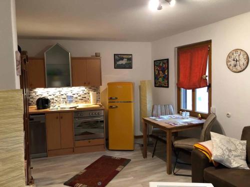 a kitchen with a yellow refrigerator and a table at Appartementhaus Blume in Bad Pyrmont