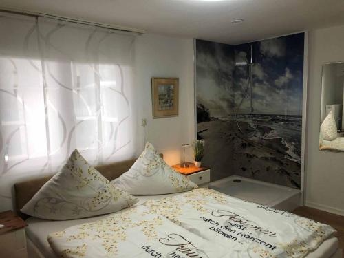 a bedroom with a bed with two pillows on it at Appartementhaus Blume in Bad Pyrmont