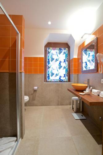 a bathroom with a shower and a sink and a toilet at Design Suite Tirano in Tirano