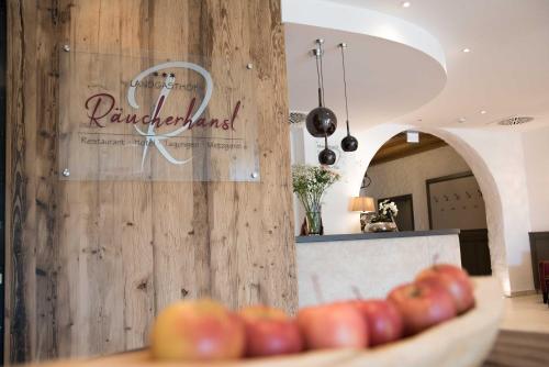 a bowl of apples on a table in a kitchen at Hotel Räucherhansl in Loiching