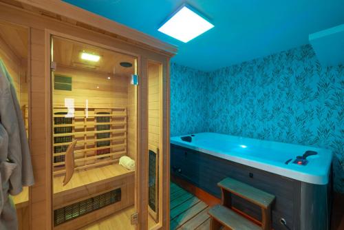 a bathroom with a tub and a walk in shower at Villa Dovecote with Private Sauna, Jacuzzi & Gym in Ston