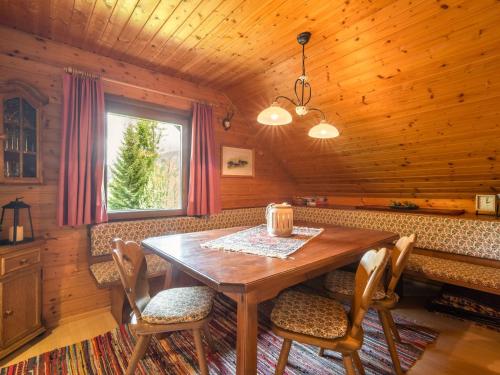 a dining room with a wooden table and chairs at Chalet in Gnesau in Carinthia with sauna in Gnesau