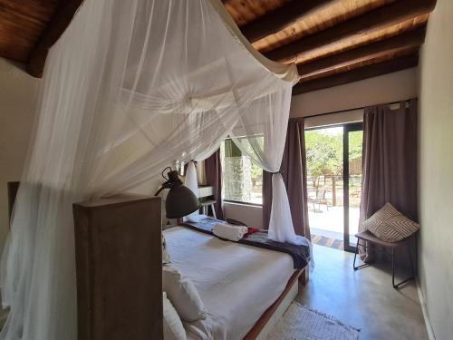A bed or beds in a room at Honey Badger Safari House