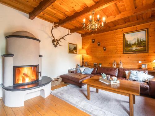 a living room with a couch and a fireplace at Chalet in Gnesau in Carinthia with sauna in Gnesau