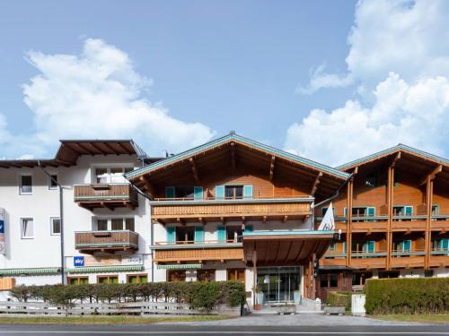 a building with wooden balconies on the side of it at Apartment in Wald near Zillertal Ski Slopes in Wald im Pinzgau