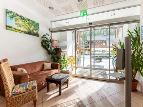 a living room with a couch and a tv at Apartment in Wald near Zillertal Ski Slopes in Wald im Pinzgau
