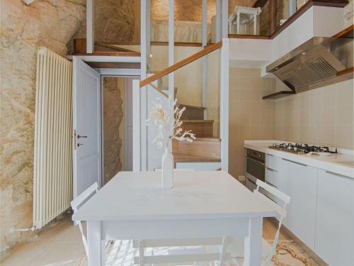 a kitchen with a white table in a room at Romantic Medieval Escape in Petrella Guidi
