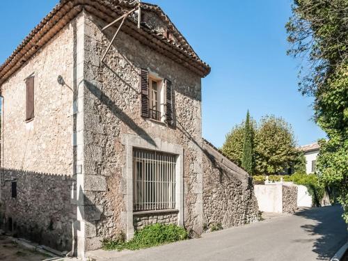 an old stone house with a window and a street at Charming holiday home in Lorgues with pool in Lorgues