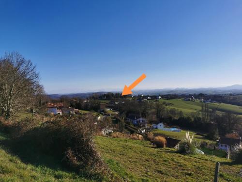 an orange object is flying over a green field at Gure Chokoa in Bardos