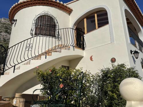 a building with a staircase and a balcony at Belvilla by OYO Villa Antonio Alto 4 pax in Benichembla