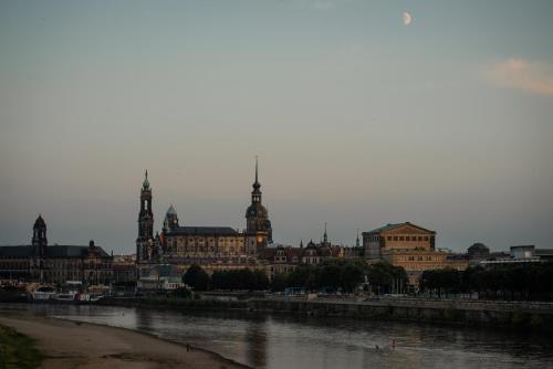 a view of a city with a river and buildings at mightyTwice Hotel Dresden in Dresden