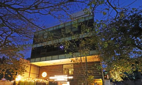 a building with a clock on the side of it at Treebo Suraksha Inn in Bengaluru