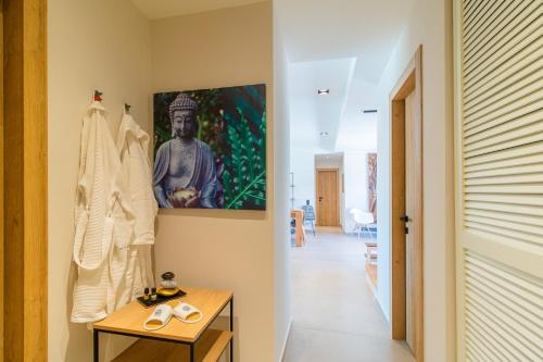 a hallway with a table and a painting on the wall at Arivallos Villa & SPA with Sauna and Wine Cellar in Litherés