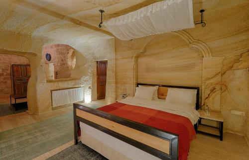 a bedroom with a large bed in a room with wooden walls at Taru Cave Suites in Urgup