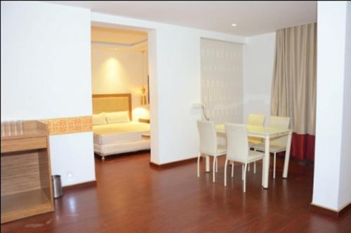 a living room with a table and chairs and a bedroom at HOTEL AMORA - Rajnandgaon in Rāj Nāndgaon