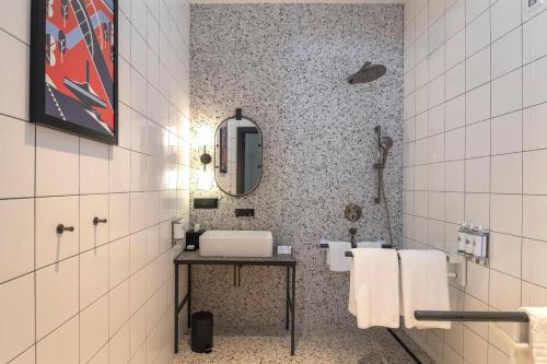 a bathroom with a sink and a mirror at Hotel Indigo Belgrade by IHG in Belgrade