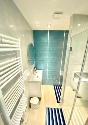 a bathroom with a shower and a toilet and a sink at Marina Apartment by Dora in Keszthely