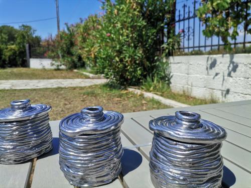 three glass vases sitting on top of a table at Green Vila in Sozopoli