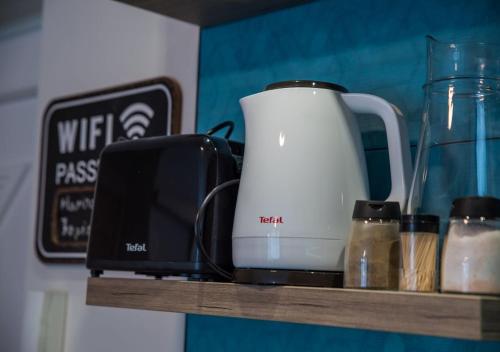 a coffee maker and a toaster on a shelf at Marina Apartment by Dora in Keszthely
