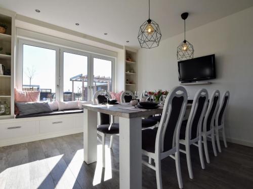 a kitchen with a dining room table and chairs at Tranquil Group Retreat in Nature in Megchelen