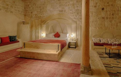 a bedroom with a large bed and a couch at Taru Cave Suites in Urgup