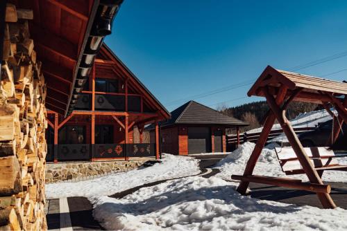 a building with snow in front of it at Chata na Czarnym Groniu in Korbielów