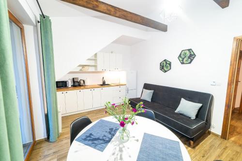 a living room with a couch and a table at Willa Tałty in Mikołajki