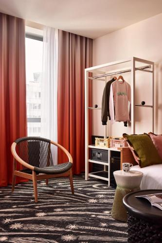 a living room with a couch and a chair at Mama Shelter Paris La Défense in Puteaux