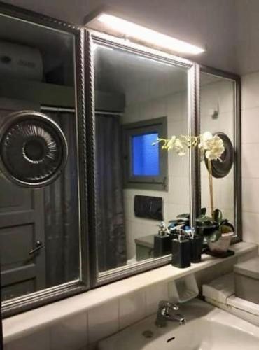 a bathroom with a mirror and a sink at Opis studio in Ornos
