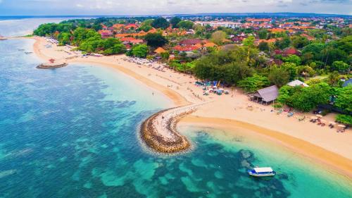 an aerial view of a beach with a group of people at Villa Siki Sanur, Relax & Enjoy in Sanur