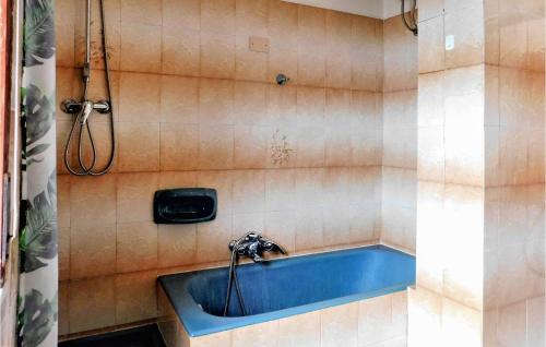a shower with a blue tub in a bathroom at Panoramic House in Palmi