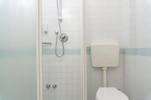 a bathroom with a shower and a toilet at Esedra Hotel in Rimini