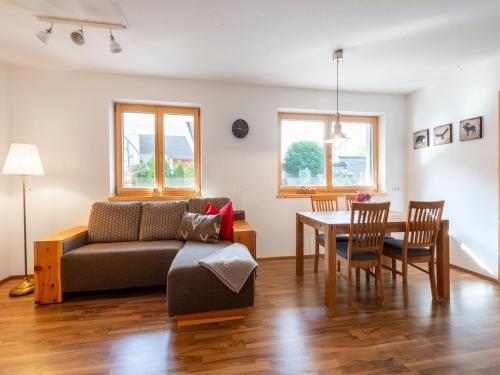 a living room with a couch and a table at Apartment to the Zillertal near F gen in Bruck am Ziller